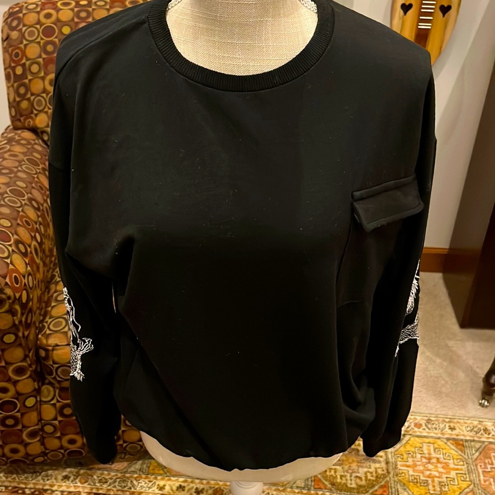 Black dragon sleeves with a pocket.